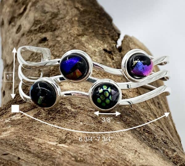 Cuff bracelet with 4 multi color glass gems in a zig zag pattern on a silver cuff