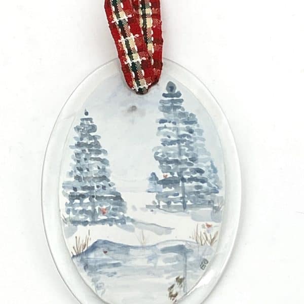 winter scene with pond and pine trees and tiny red cardinals
