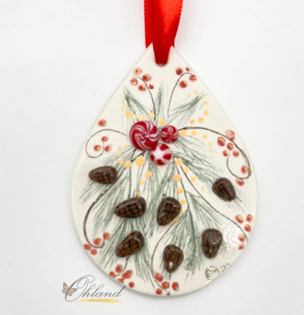 christmas ornament with hand painted pine spray, red berries, pine cones and peppermint decorations