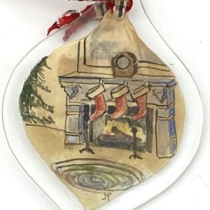 three stockings by a fire ornament
