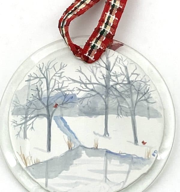 blue and grey painted winter scene on a 3" round ornament with cardinals