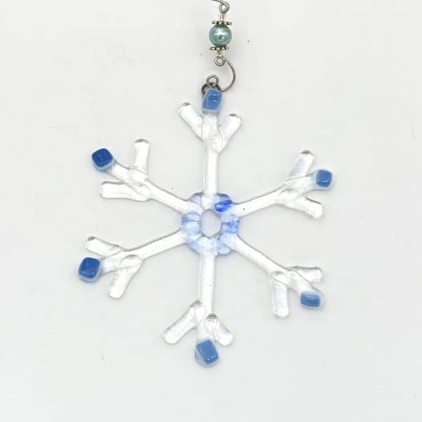 clear iridescent snow flake with blue accents 4" across