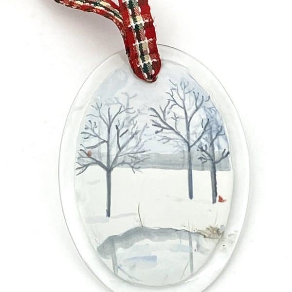 winter scene with branched trees, pond and cardinals