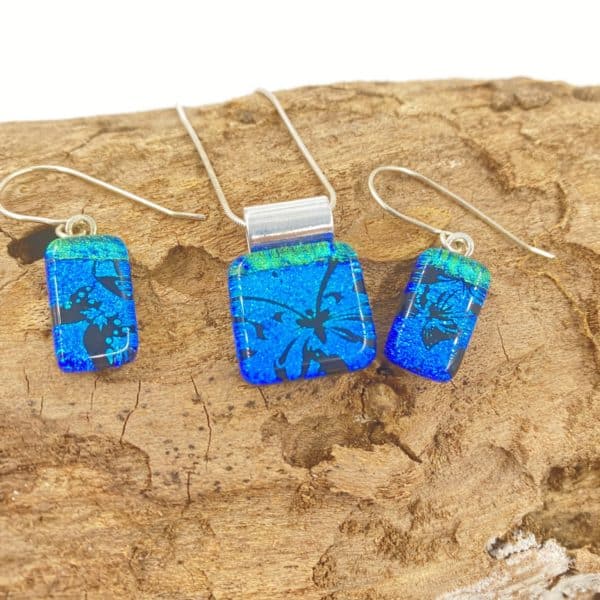 Pendant and Earring set in square/rectangular shape with black butterfly images on a cobalt blue background and green accent at top. Glass is very very shiny and sparkly