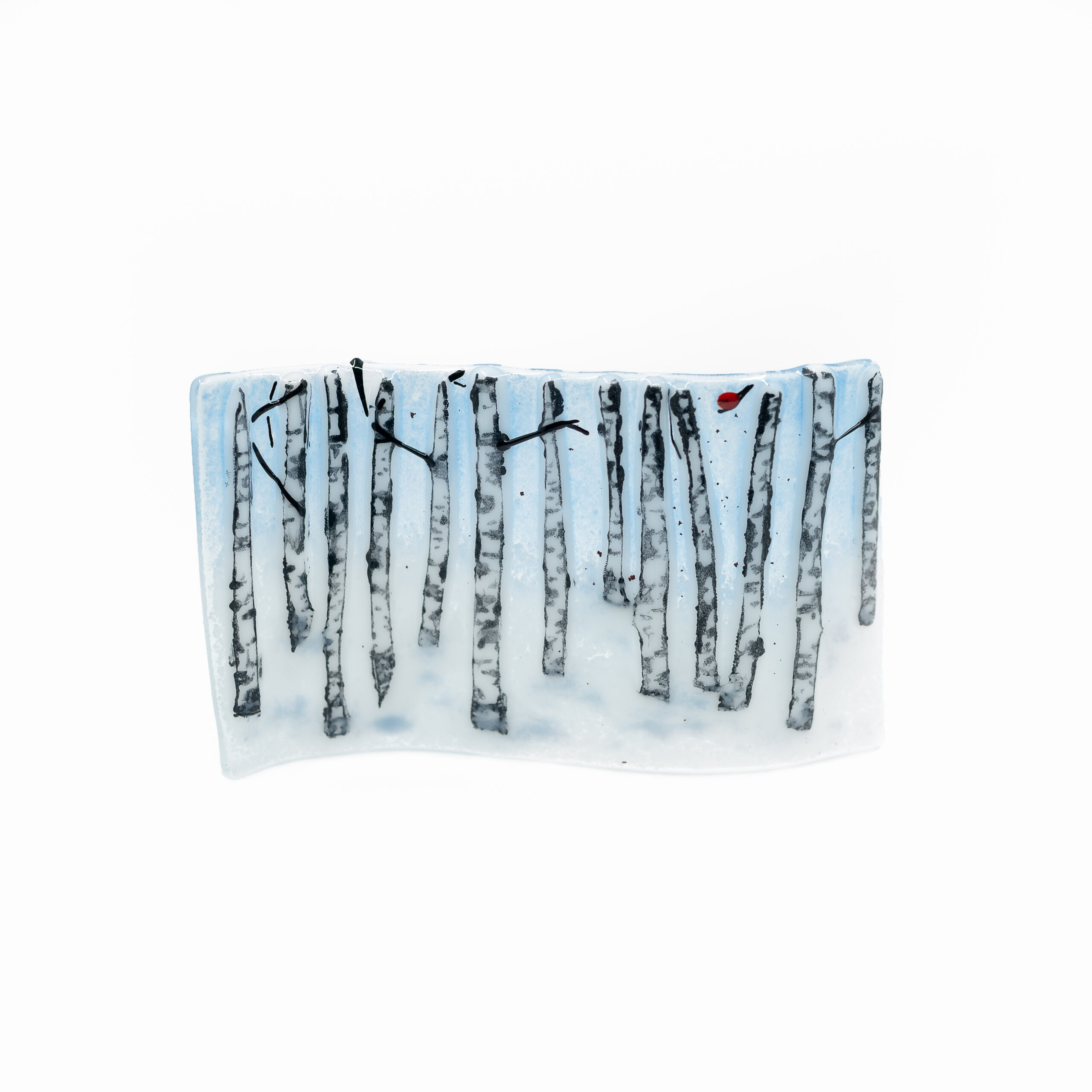 small glass art panel with birch tree trunks, snow and one tiny cardinal sitting on a branch, art is 3.25'x5.5" and is curved and stands on its edge